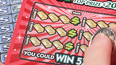 scratching off lottery ticket