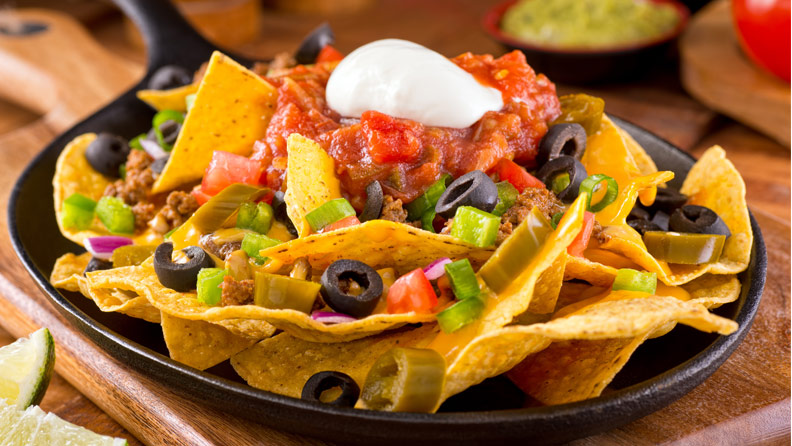 Nachos with salsa, olives and sour cream