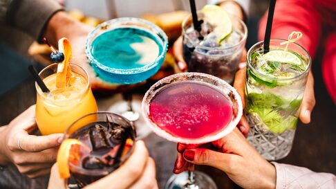 Picture of 6 people holding drinks doing a toast