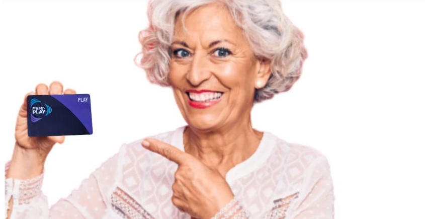 woman smiling with a penn play card